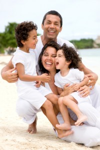 Happy step-family vacationing on the beach.